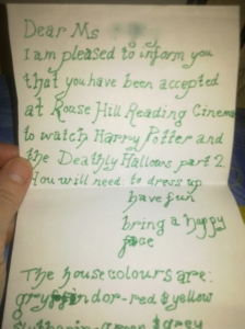 Photo of an invitation written in green fountain pen.